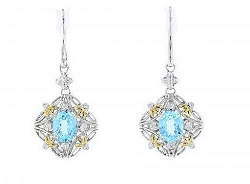 Italian sterling silver earrings with a blue topaz center stone, 0.24ct. diamonds and solid 14K yellow gold accents.